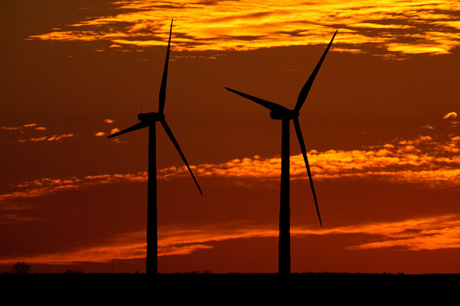 Wind turbines near Ellsworth, Kan., are silhouetted against the sky.