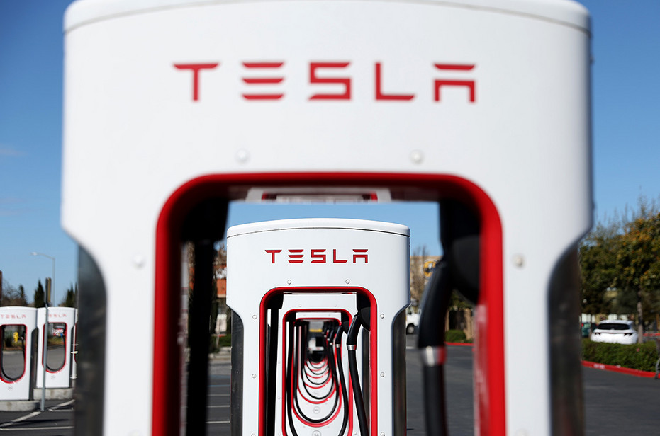 A line of Tesla Superchargers are seen at a station in Petaluma, Calif.